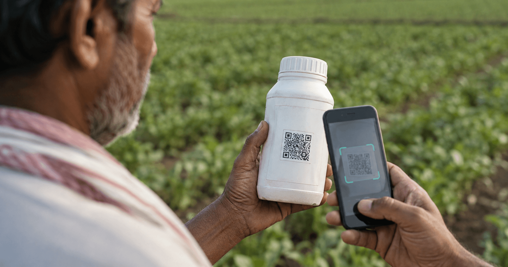 Indian farmer scanning a pesticide bottle's QR code with a smartphone in a field, verifying product authenticity